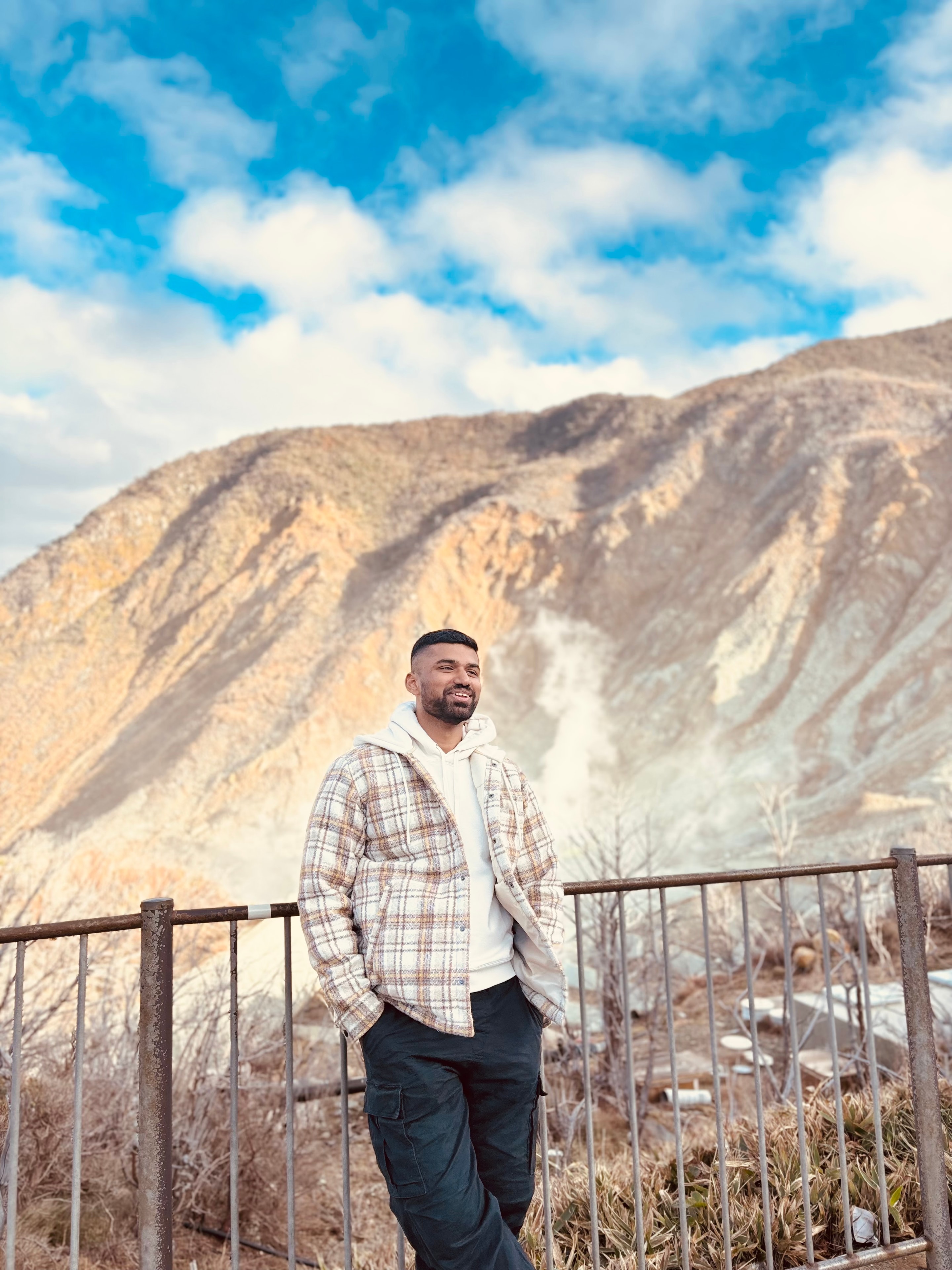 Pranav Saravanan standing before a mountain landscape